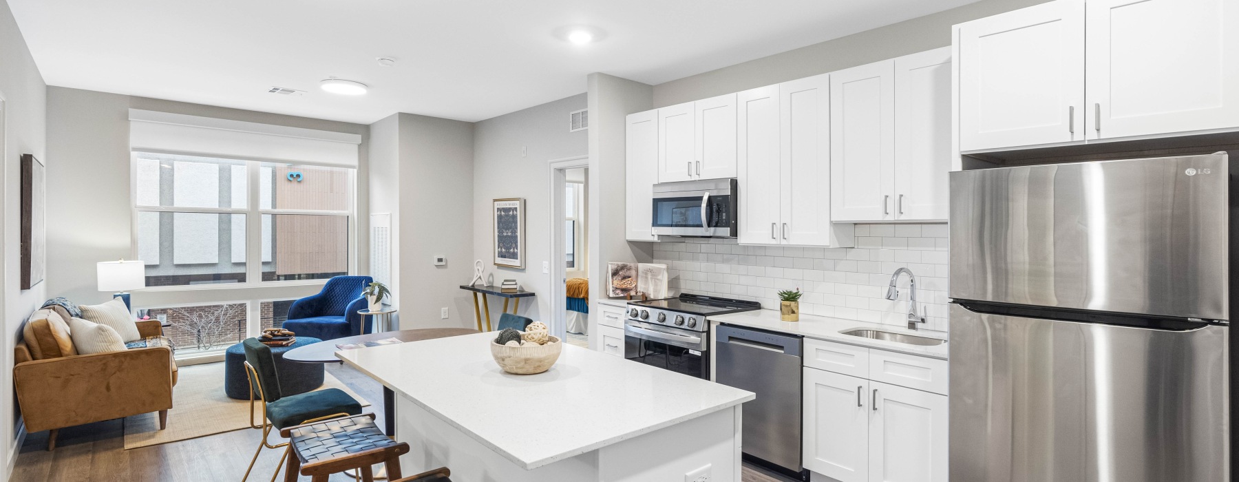 kitchen with white cabinets and stainless steel appliances white subway backsplash